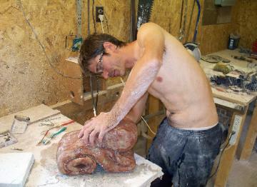 The Stone Sculptor working in his studio.
